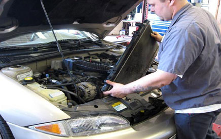Mechanic replaces radiator