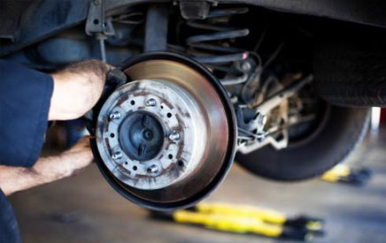 Mechanic puts new tires on a car