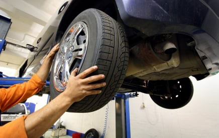 Mechanic puts new tires on a car